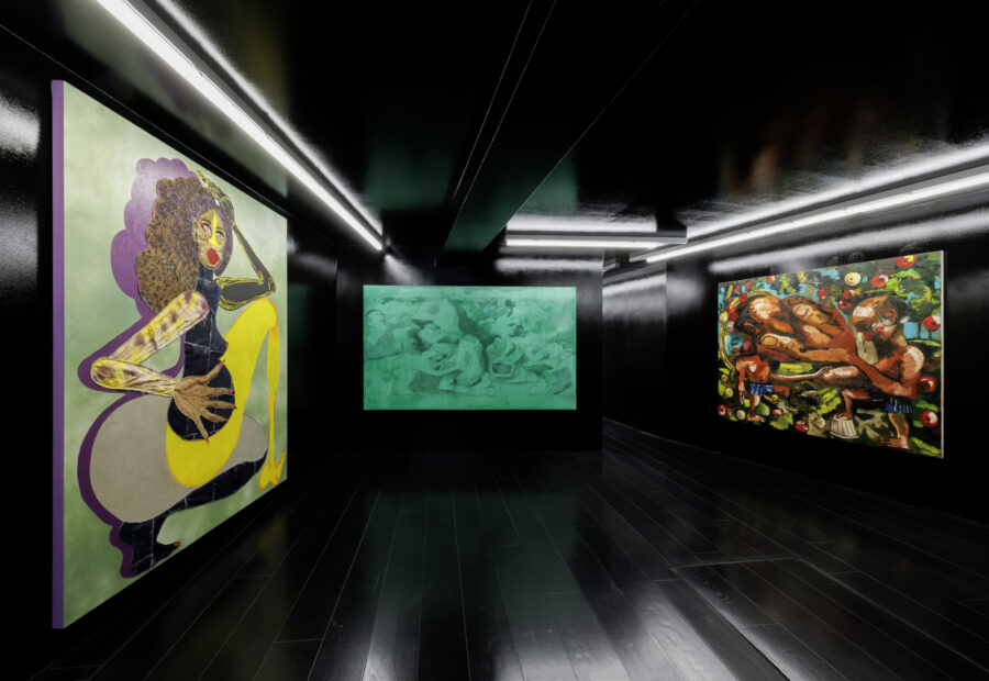 Three large abstract paintings displayed in a modern, dark gallery with linear ceiling lighting.