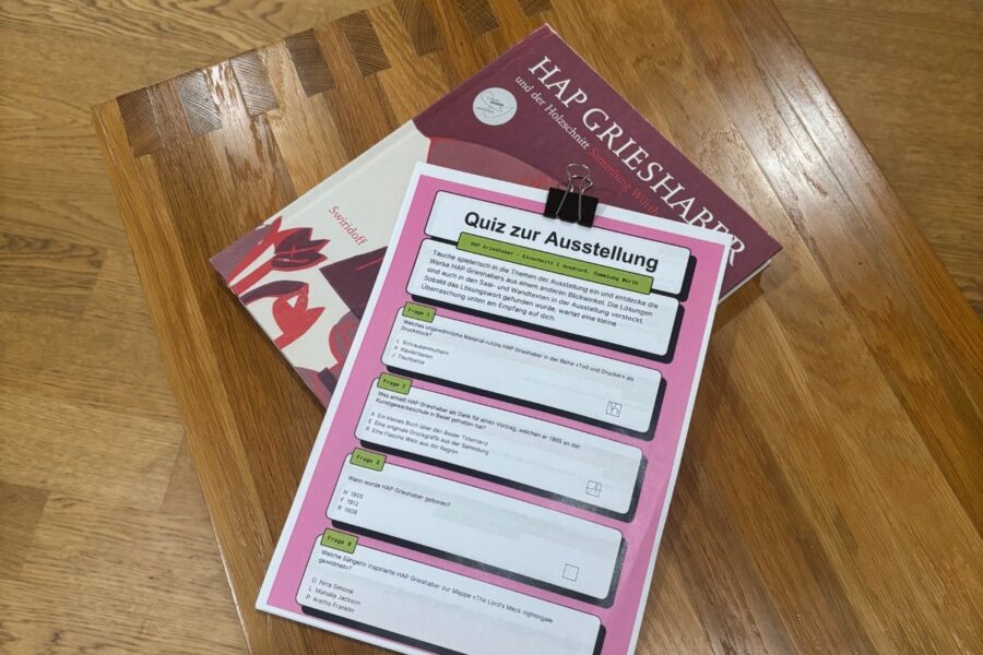 A quiz for an art exhibition about Hap Grieshaber resting on a book about the artist.
